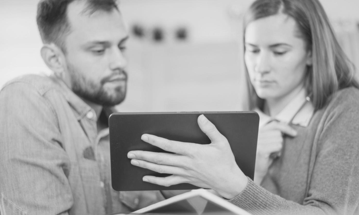 Financial analyst working on complex modeling spreadsheet with multiple data sources